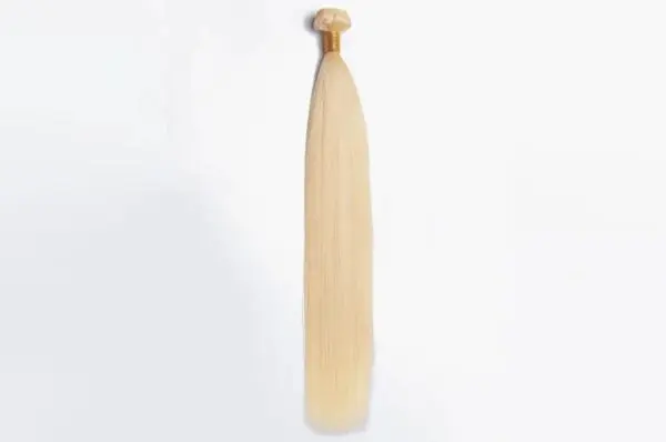 A blonde hair extension hanging on the wall.