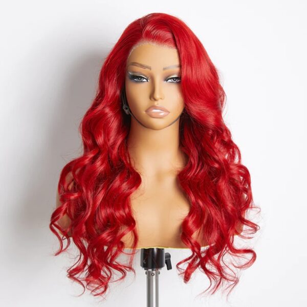 A red wig sitting on top of a mannequin head.